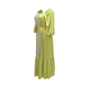 Detailed view of sage green satin kaftan with bubble sleeves and lace trim details
