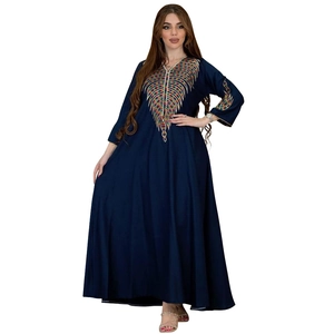 Detailed close-up of vibrant floral embroidery on a dark blue kaftan dress for women