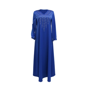 Detail of golden beaded leaf embroidery on the V-neck and cuffs of the navy maxi dress