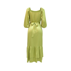 Detail of light green satin kaftan dress with square neck and puffed sleeves