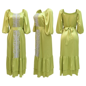 Detailed views of light green satin kaftan dress with silver lace trim and tiered hem