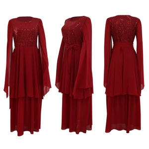 Detail of red sequined bodice and flowing cape sleeves on evening gown with waist belt