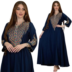 Detailed close-up of colorful embroidery patterns on navy blue long-sleeved dress