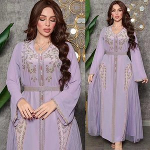Detailed close-up of lavender kaftan dress with golden sequins and beadwork embroidery