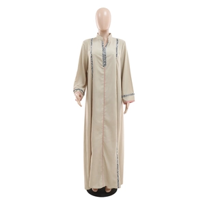 Détail de robe Jalabiya kaki avec broderies florales au col et poignets à passepoil rose