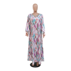 Detail of colorful geometric print maxi dress with decorative beadwork on neckline