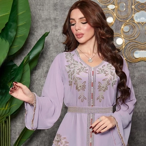 Detail of light purple kaftan dress with gold beadwork and intricate floral embroidery