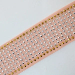 Close-up of pink fabric belt with gold and silver rhinestones for kaftan dress
