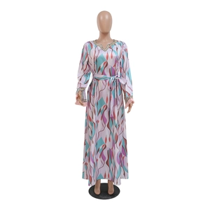 Detail of V-neckline with shimmering beadwork and colorful wave pattern on long dress