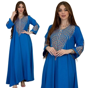 Close-up of colorful stripe embroidery and vibrant royal blue fabric of the long robe