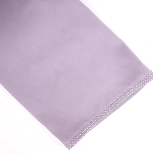 Close-up of lavender fabric edge decorated with double rows of silver rhinestones
