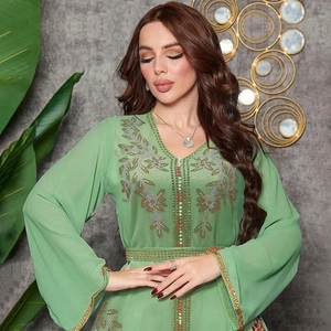 Detail of light green Kaftan dress showing intricate gold embroidery and colorful beads