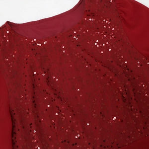 Detail of red sequin bodice with elegant round neck and layered mesh fabric textures