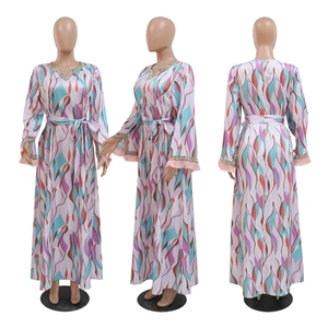 Detail of sequin embroidery and pink tassels on bohemian floral long sleeve dress