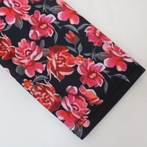 Macro shot of rose floral print and high-elastic stitching on the fabric sleeve
