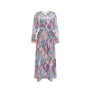 Detail of V-neckline with intricate sequin embroidery on printed long-sleeve maxi dress