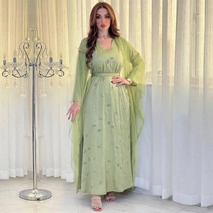 Close-up of light green Abaya dress with silver sequin embroidery and sheer mesh detail
