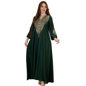 Detailed embroidery with colorful feather patterns on dark green kaftan dress