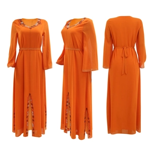 Détails de la broderie de perles et des strass sur la robe en mousseline orange vif