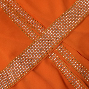 Close-up of bright orange chiffon kaftan dress with intricate multi-row rhinestone details