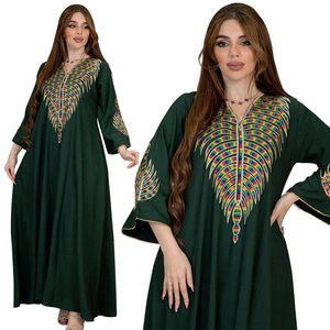 Detailed view of colorful feather embroidery and gold piping on dark green long kaftan