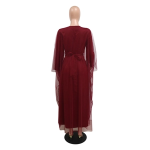 Detail view of the back of a burgundy rhinestones V-neck dress with mesh cape sleeves