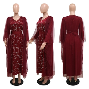 Detail view of burgundy mesh V-neck dress with rhinestone patterns and sheer cape layering