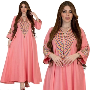 Detail of pink V-neck maxi dress featuring colorful geometric embroidery on the chest