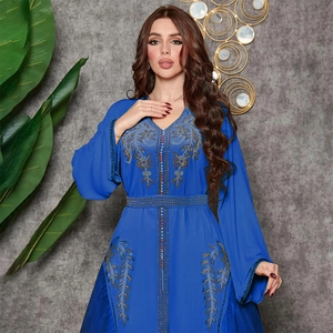 Detail showing intricate rhinestone patterns on navy blue kaftan dress sleeves
