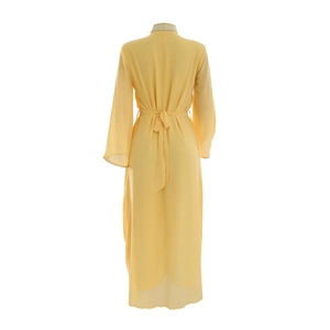 Detail view of the high-collar neckline with pearl beads on a yellow chiffon kaftan