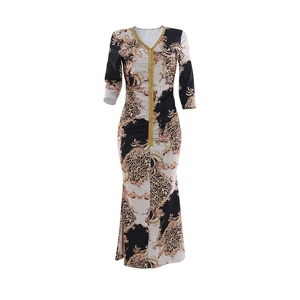 Close-up of V-neckline with sequins and gold Baroque print on a slim leopard dress