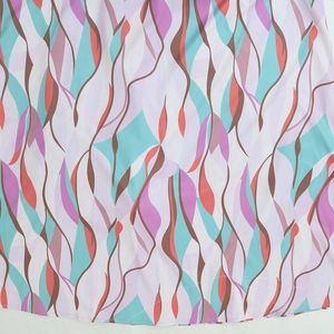 Detail of colorful abstract wave print fabric with neat stitching on white background
