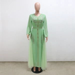 Detail of light green kaftan dress with exquisite crystal beadwork and mesh skirt