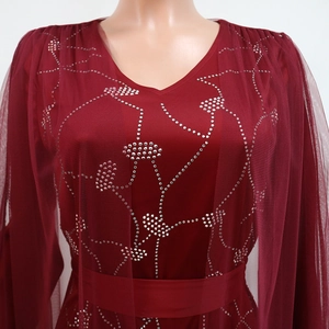Detailed view of rhinestone floral patterns on burgundy V-neck mesh dress