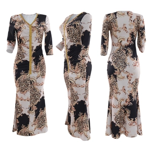 Detail of V-neck kaftan dress with leopard print, baroque pattern and gold sequins