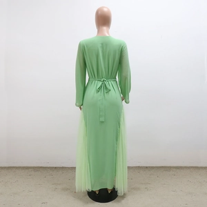 Rear view of light green kaftan dress featuring pleated mesh panels and beaded waist belt