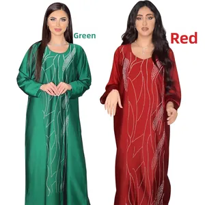 Detail of green and red satin abaya dresses featuring elegant rhinestone vertical patterns