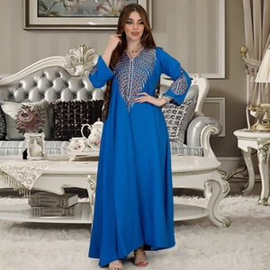 Close-up of vibrant royal blue kaftan dress featuring colorful geometric embroidery details