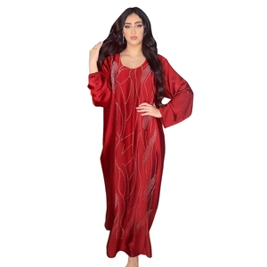 Detailed view of red satin kaftan dress featuring elegant wavy rhinestone patterns