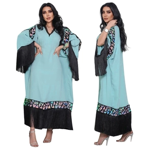 Elegant light blue kaftan dress with black tassels and bohemian geometric trim patterns