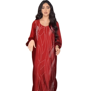 Detail of red loose-fit maxi abaya featuring white wavy dotted patterns and silky texture