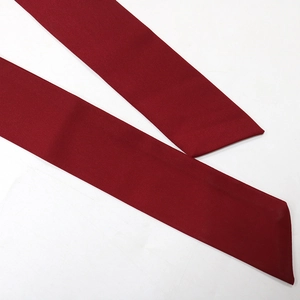 Detail view of the deep red mesh fabric and premium V-neck rhinestone dress waistband