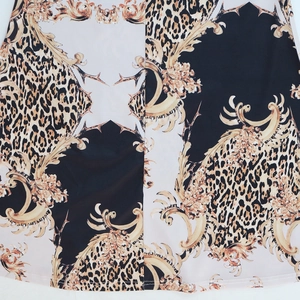 Close-up of leopard and baroque print on kaftan dress fabric with neat bottom hem stitching
