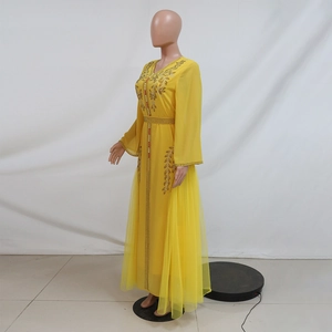 Detail of yellow kaftan dress with gold and red beadwork and crystal embellishments