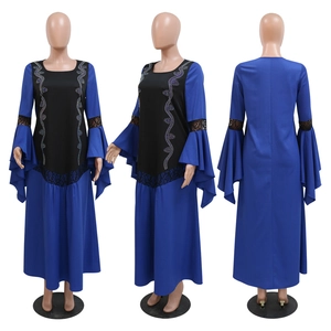 Detail of rhinestone patterns and ruffled lace sleeves on a navy kaftan dress
