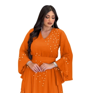 Detail of beaded pearls and rhinestones on orange chiffon V-neck dress with flare sleeves