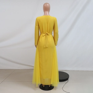 Detail of yellow kaftan dress featuring a rear waist bow tie and sheer mesh side panels