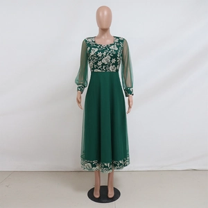 Detail of white floral embroidery on dark green mesh kaftan dress with lantern sleeves