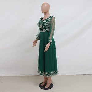 Detail of dark green kaftan dress with white floral embroidery on mesh sleeves