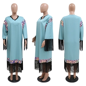 Detail view of light blue robe with black fringe hem and colorful sequin geometric patterns
